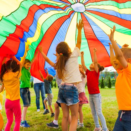 Joyous,Classmates,Jumping,Under,Colorful,Parachute