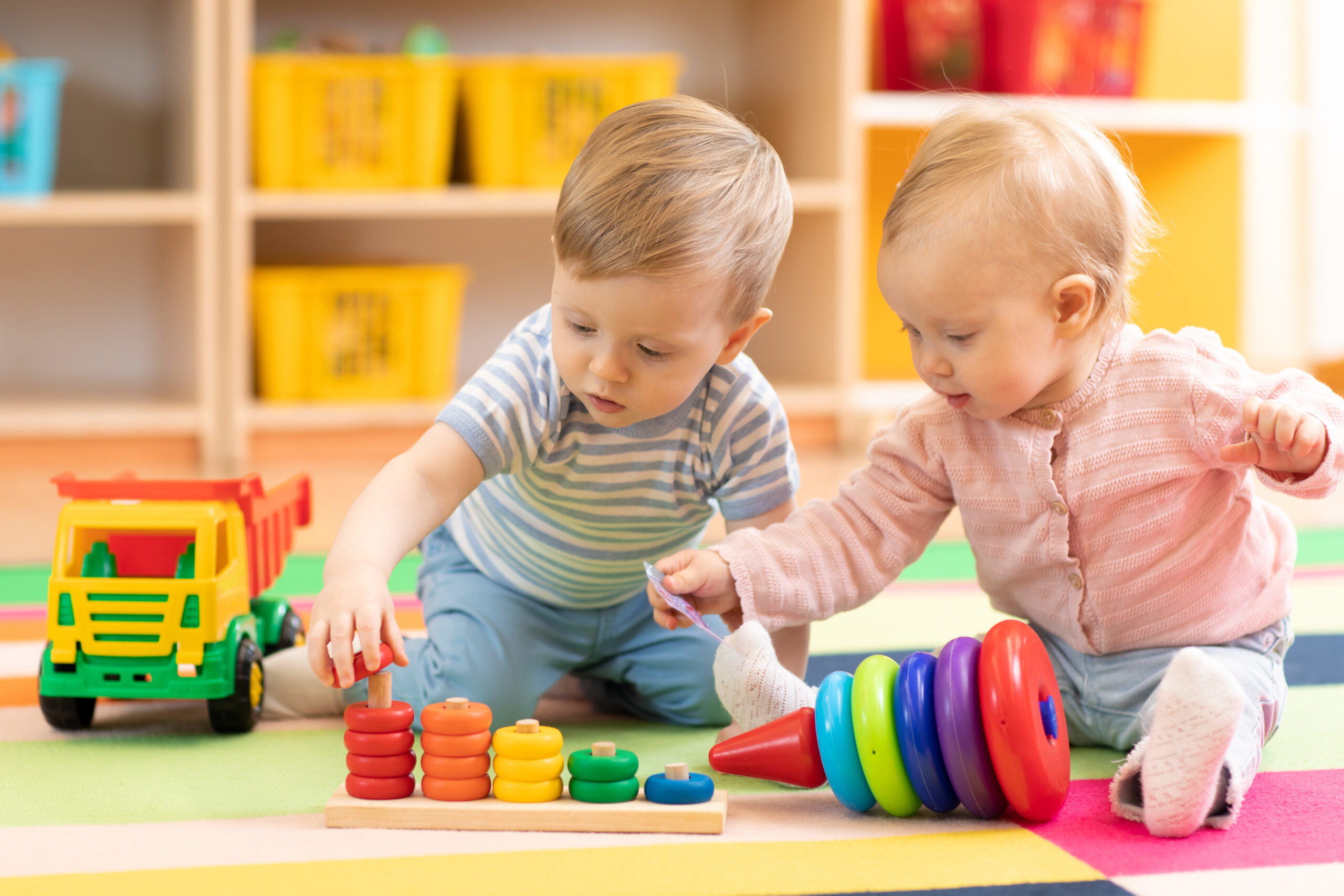 Preschool,Boy,And,Girl,Playing,On,Floor,With,Educational,Toys.