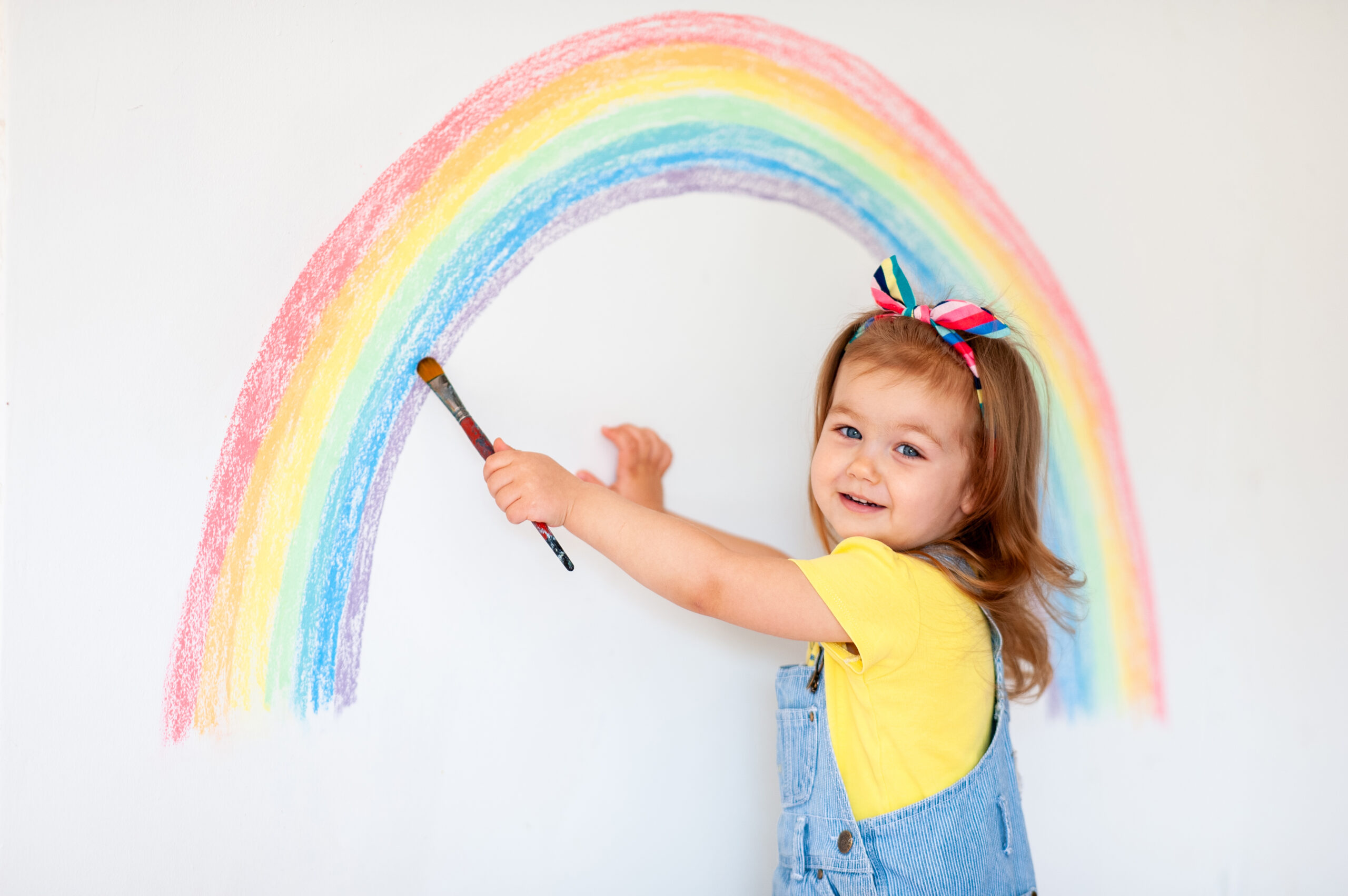 Super,Cute,Little,Girl,Drawing,Rainbow,On,White,Wall,At